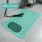 Green bath mat with textured surface on a tiled floor, featuring the text &
